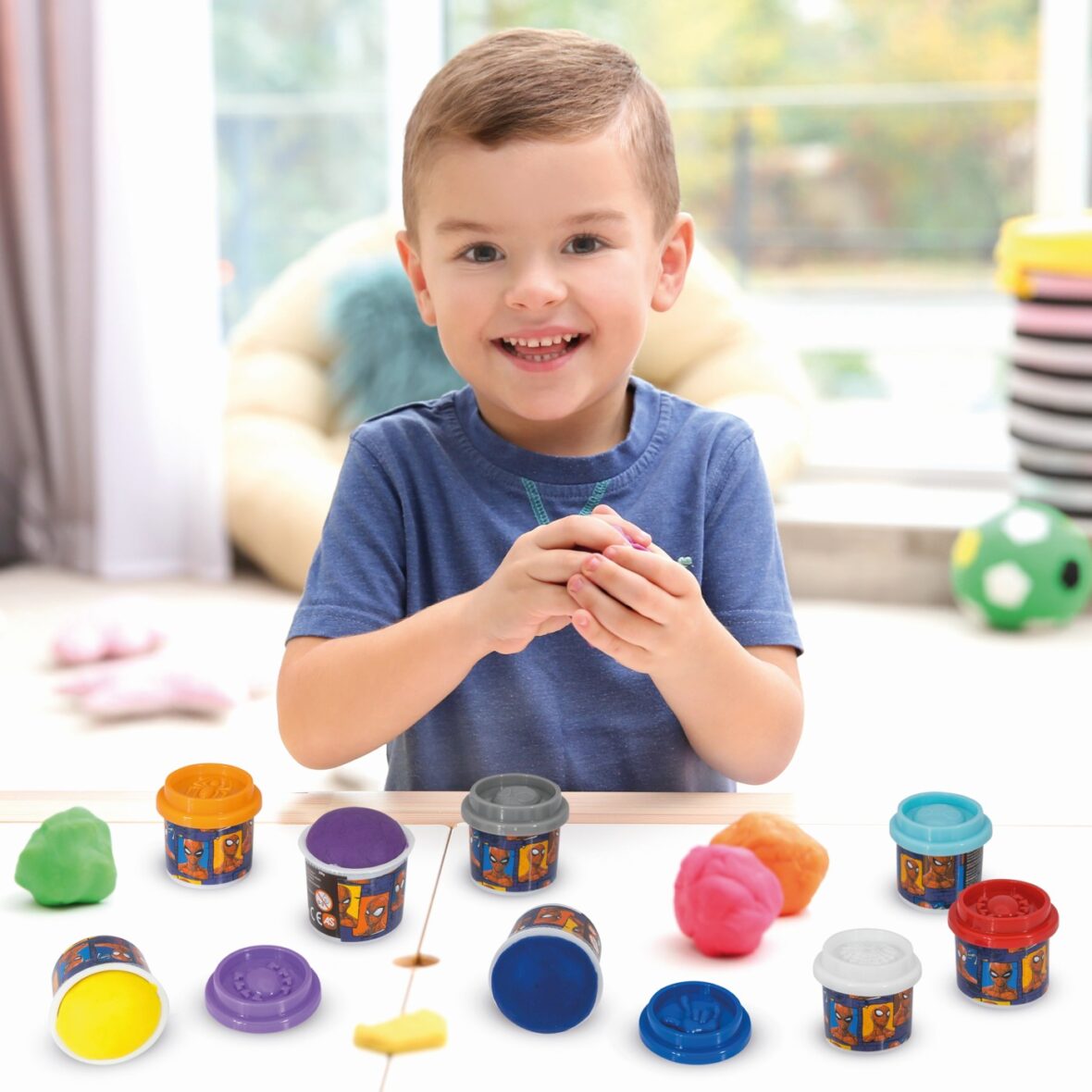 Little boy engaged in playdough modeling at daycare