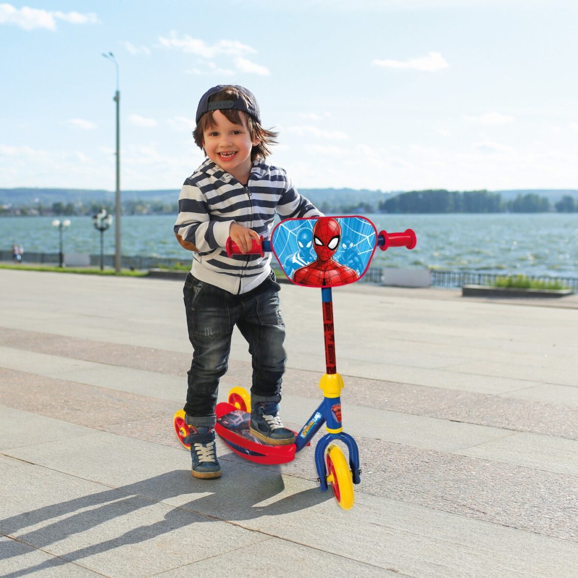 Little boy with three-wheeled scooter