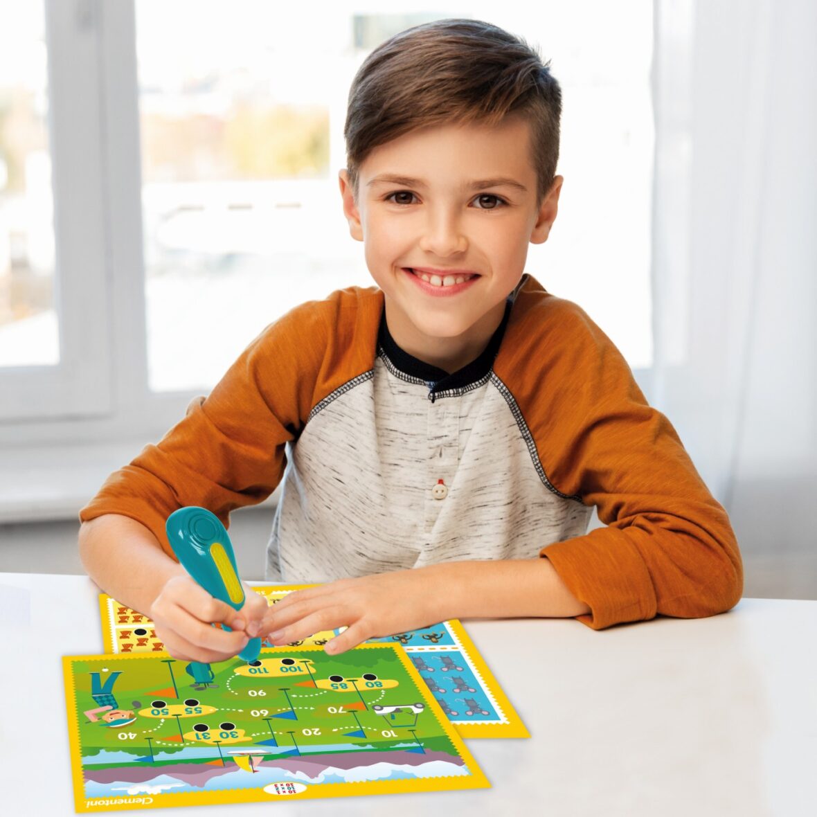 boy doing homework and writing to notebook at home