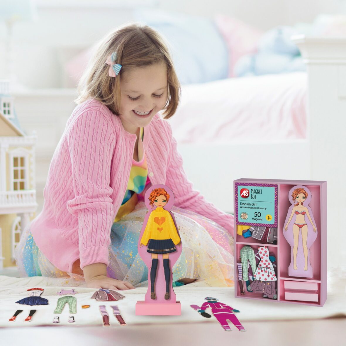 Little girl playing with doll house. Kid with toys